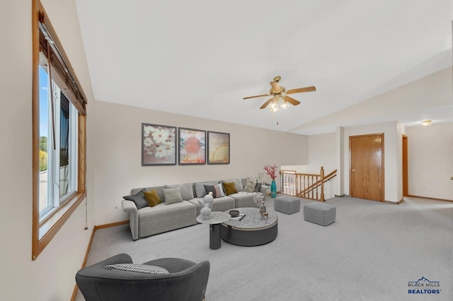 carpeted living room featuring ceiling fan and lofted ceiling