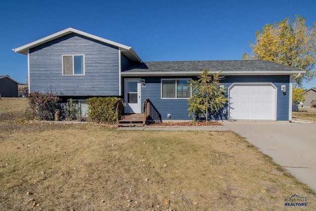 view of front of house featuring a front yard and a garage