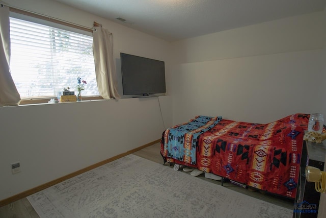 bedroom with wood-type flooring