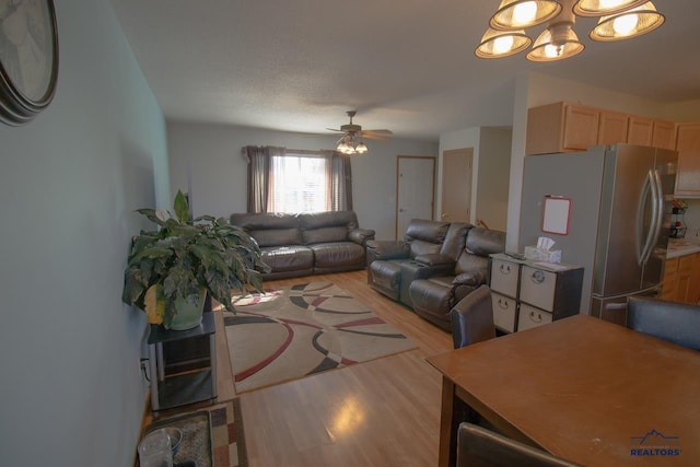 living room with light hardwood / wood-style flooring and ceiling fan