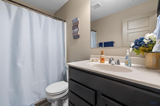 bathroom featuring vanity, toilet, curtained shower, and hardwood / wood-style floors