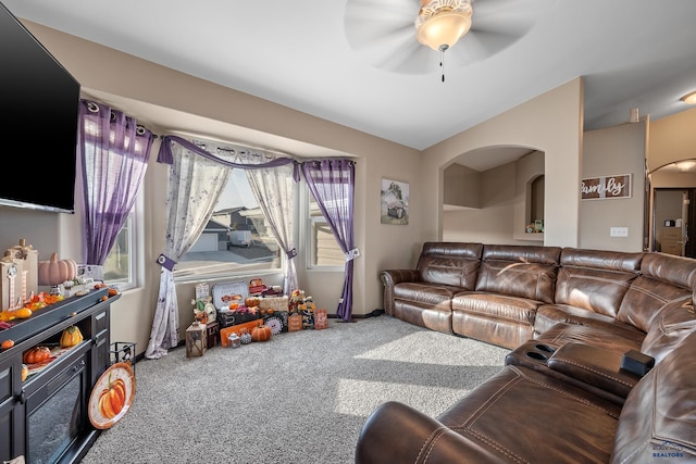 carpeted living room with ceiling fan and plenty of natural light