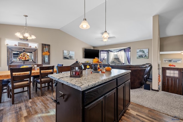 kitchen with lofted ceiling, pendant lighting, dark hardwood / wood-style floors, and a kitchen island