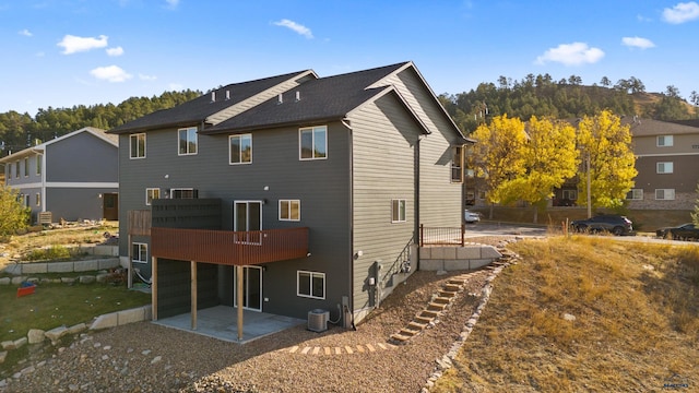 back of property featuring central AC, a patio area, and a wooden deck