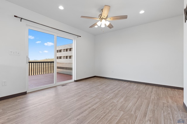 spare room with ceiling fan and light hardwood / wood-style flooring