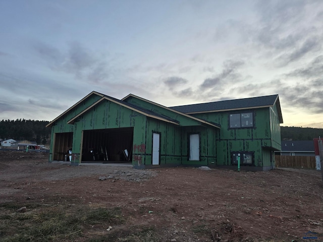 outdoor structure at dusk featuring a garage