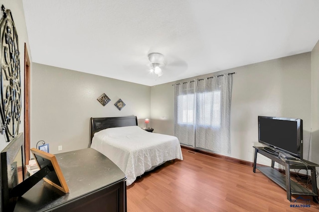 bedroom with hardwood / wood-style floors and ceiling fan