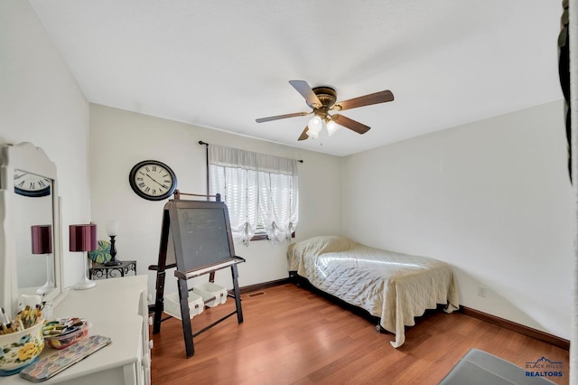 bedroom with hardwood / wood-style floors and ceiling fan