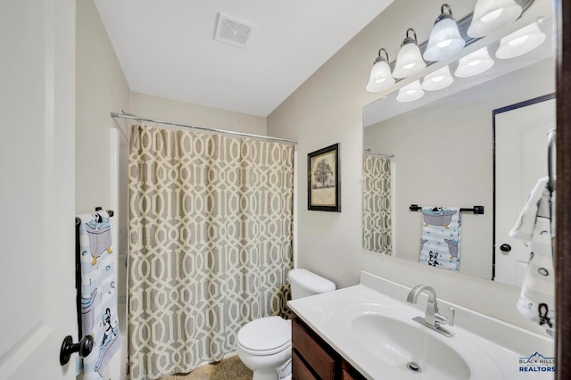 bathroom featuring vanity, tile patterned floors, toilet, and walk in shower