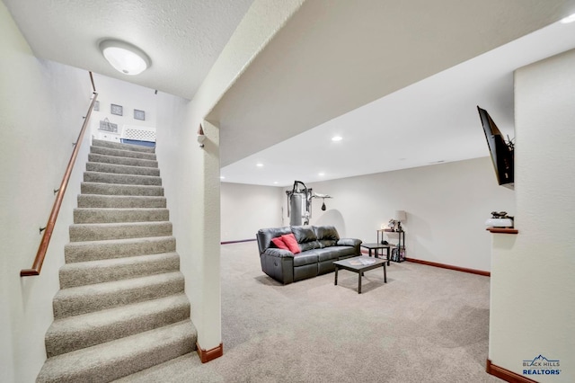 living room with a textured ceiling and light colored carpet