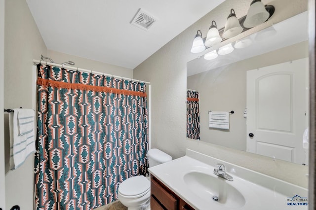 bathroom with toilet, curtained shower, and vanity