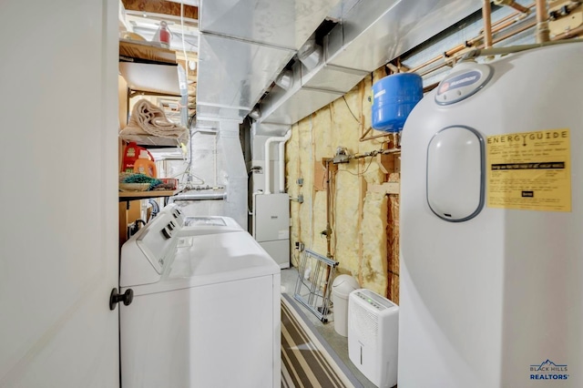 laundry area with electric water heater and separate washer and dryer