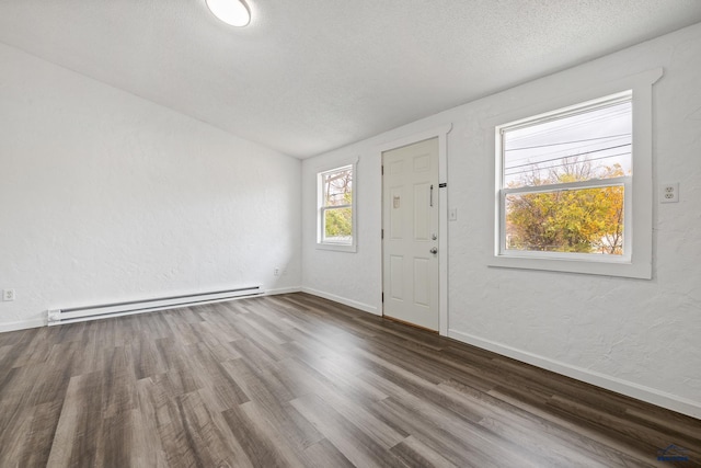 foyer entrance featuring a textured ceiling, dark hardwood / wood-style flooring, and baseboard heating