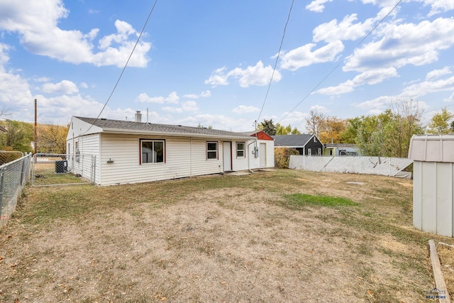 rear view of property with a lawn