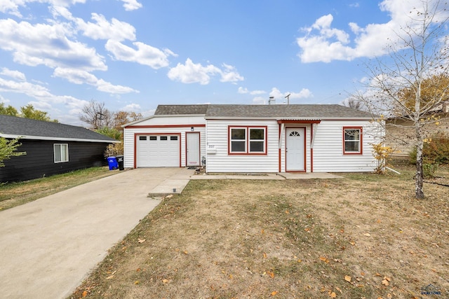 ranch-style house with a garage and a front lawn