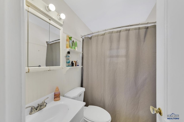 1918 Ivy Ave, Rapid City, SD 57701 - bathroom with vanity, curtained shower, and toilet
