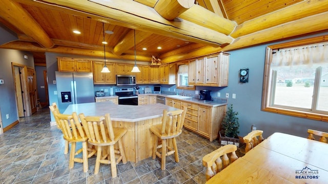 kitchen with beam ceiling, light countertops, appliances with stainless steel finishes, a sink, and wooden ceiling