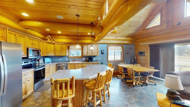 kitchen with stainless steel appliances, light countertops, a sink, a kitchen island, and wooden ceiling