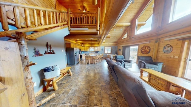 living room with high vaulted ceiling, wooden ceiling, and stone finish floor