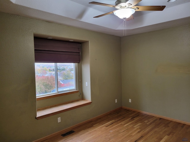 empty room featuring wood-type flooring and ceiling fan