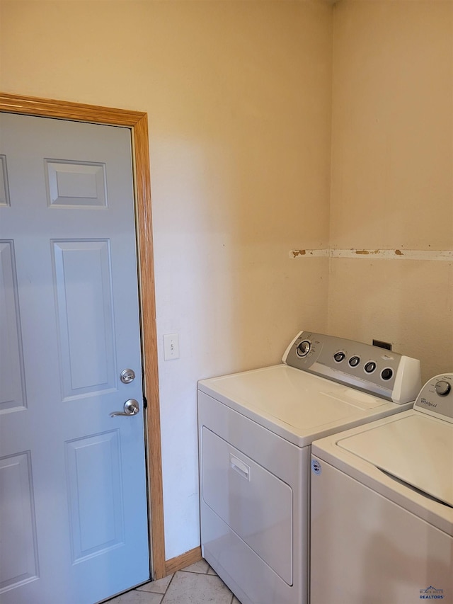 washroom with light tile patterned floors and washing machine and clothes dryer