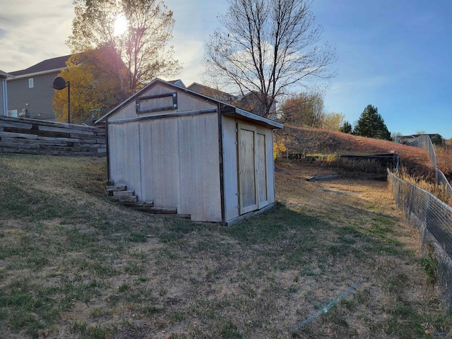 outdoor structure at dusk featuring a lawn