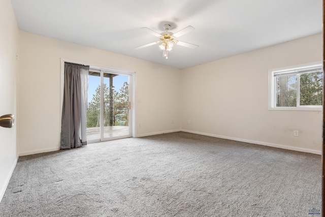 empty room featuring carpet flooring and ceiling fan