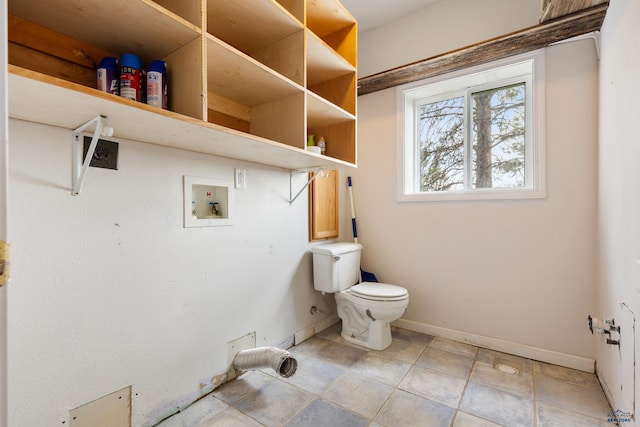 bathroom with toilet and tile patterned flooring