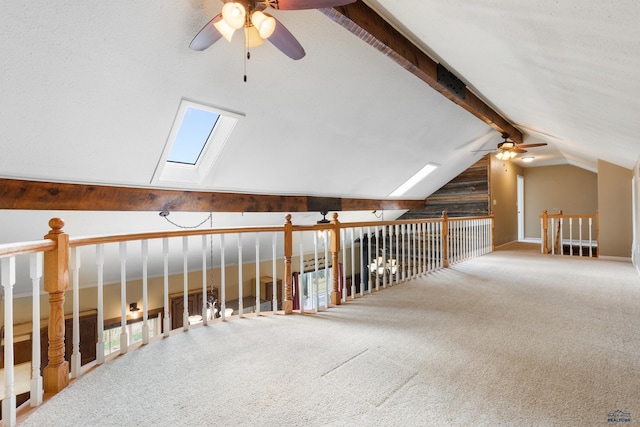 bonus room with vaulted ceiling with skylight, carpet floors, and plenty of natural light