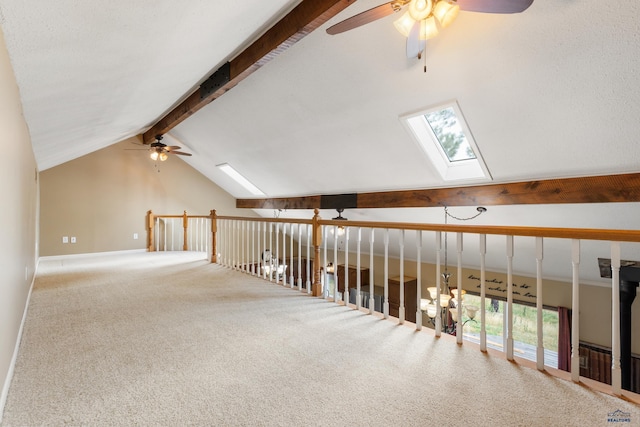 bonus room with ceiling fan, vaulted ceiling with skylight, and carpet floors