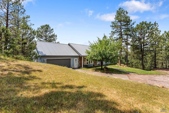 view of front of house with a garage and a front lawn