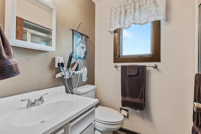 bathroom featuring toilet and vanity