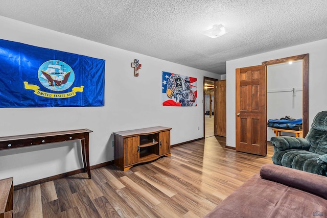 living room with hardwood / wood-style flooring and a textured ceiling