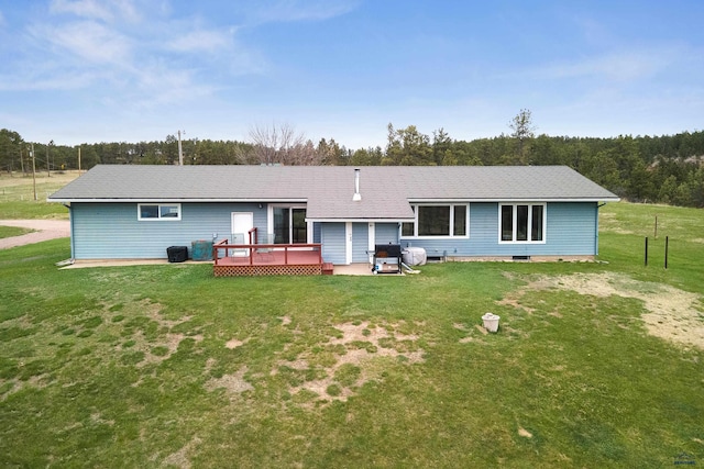 back of house with a deck and a lawn