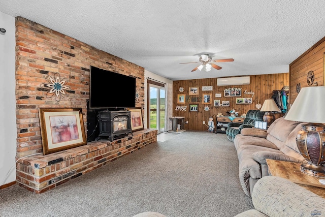 living room featuring a wall mounted AC, a textured ceiling, a wood stove, and wood walls