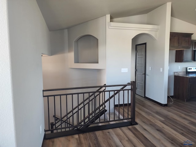 interior space featuring lofted ceiling and dark hardwood / wood-style flooring