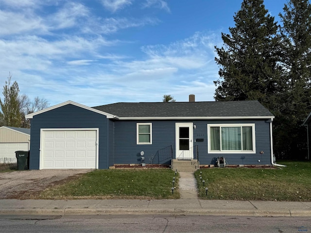 single story home with a garage and a front lawn