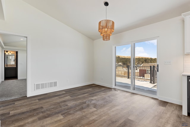 unfurnished dining area featuring hardwood / wood-style floors and a chandelier