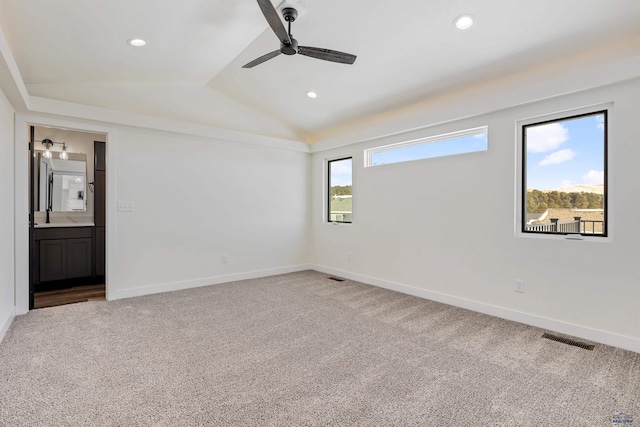 unfurnished room featuring ceiling fan, sink, lofted ceiling, and carpet floors