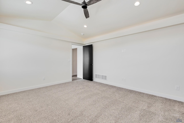 carpeted spare room with vaulted ceiling and ceiling fan