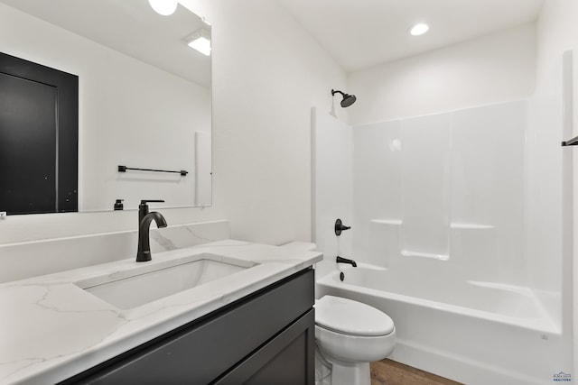 full bathroom featuring toilet, bathtub / shower combination, vanity, and hardwood / wood-style floors