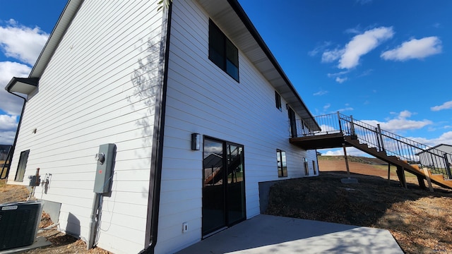 view of property exterior with a patio area and central AC