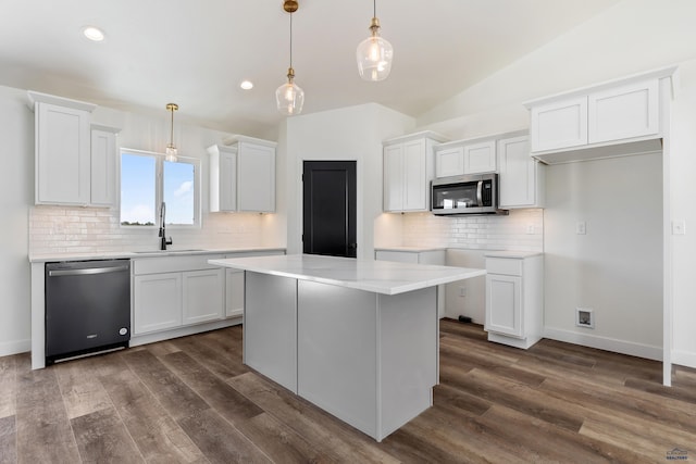 kitchen with dark hardwood / wood-style flooring, white cabinetry, sink, and appliances with stainless steel finishes