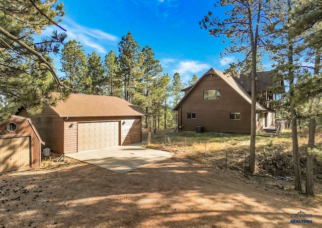 view of side of property featuring a garage and an outdoor structure