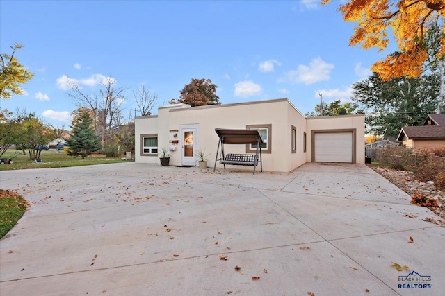 pueblo-style house featuring a garage