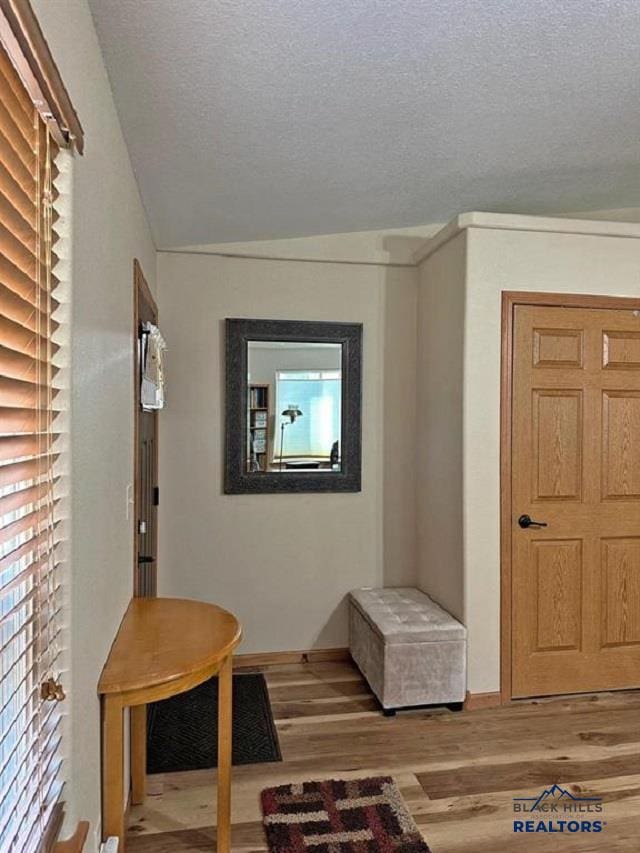 interior space with hardwood / wood-style floors and a textured ceiling