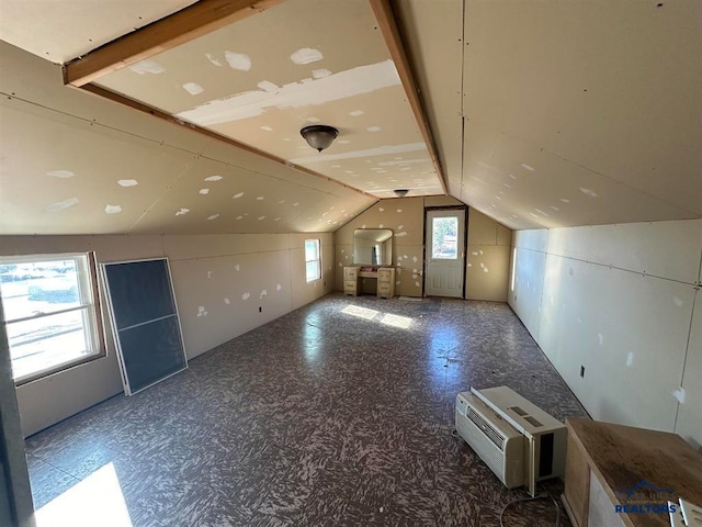 bonus room featuring lofted ceiling with beams and a wealth of natural light