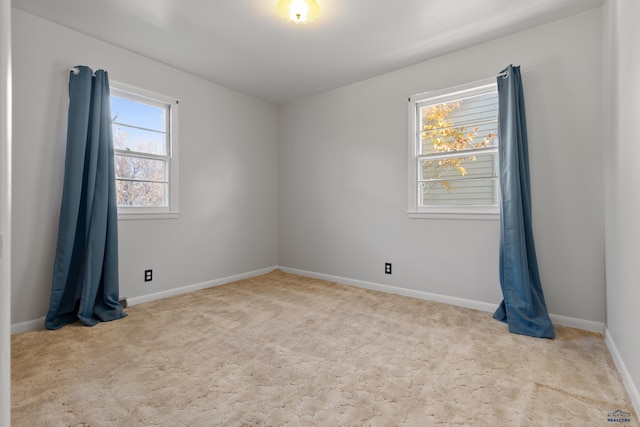 unfurnished room featuring light carpet