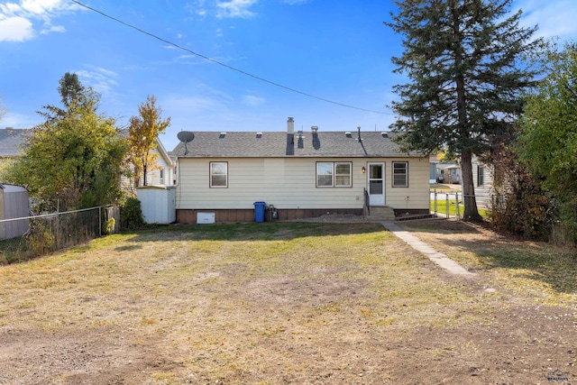 rear view of property featuring a yard