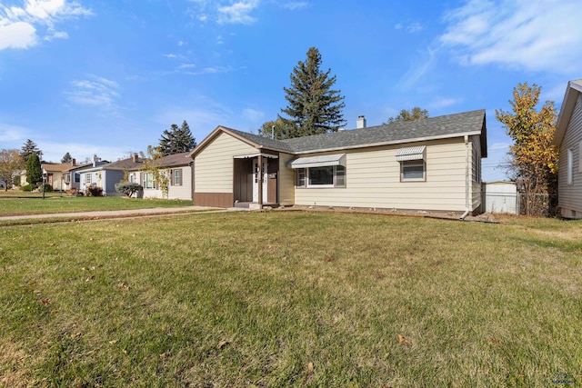 ranch-style home featuring a front yard